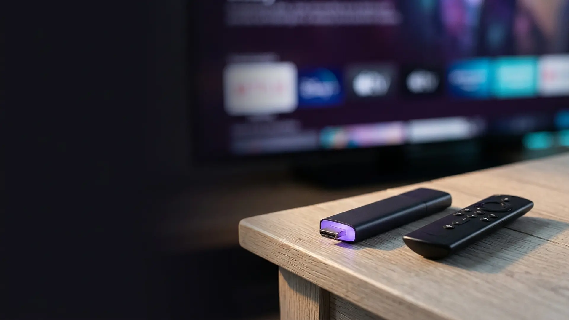 A streaming stick and remote with dramatic rim lighting