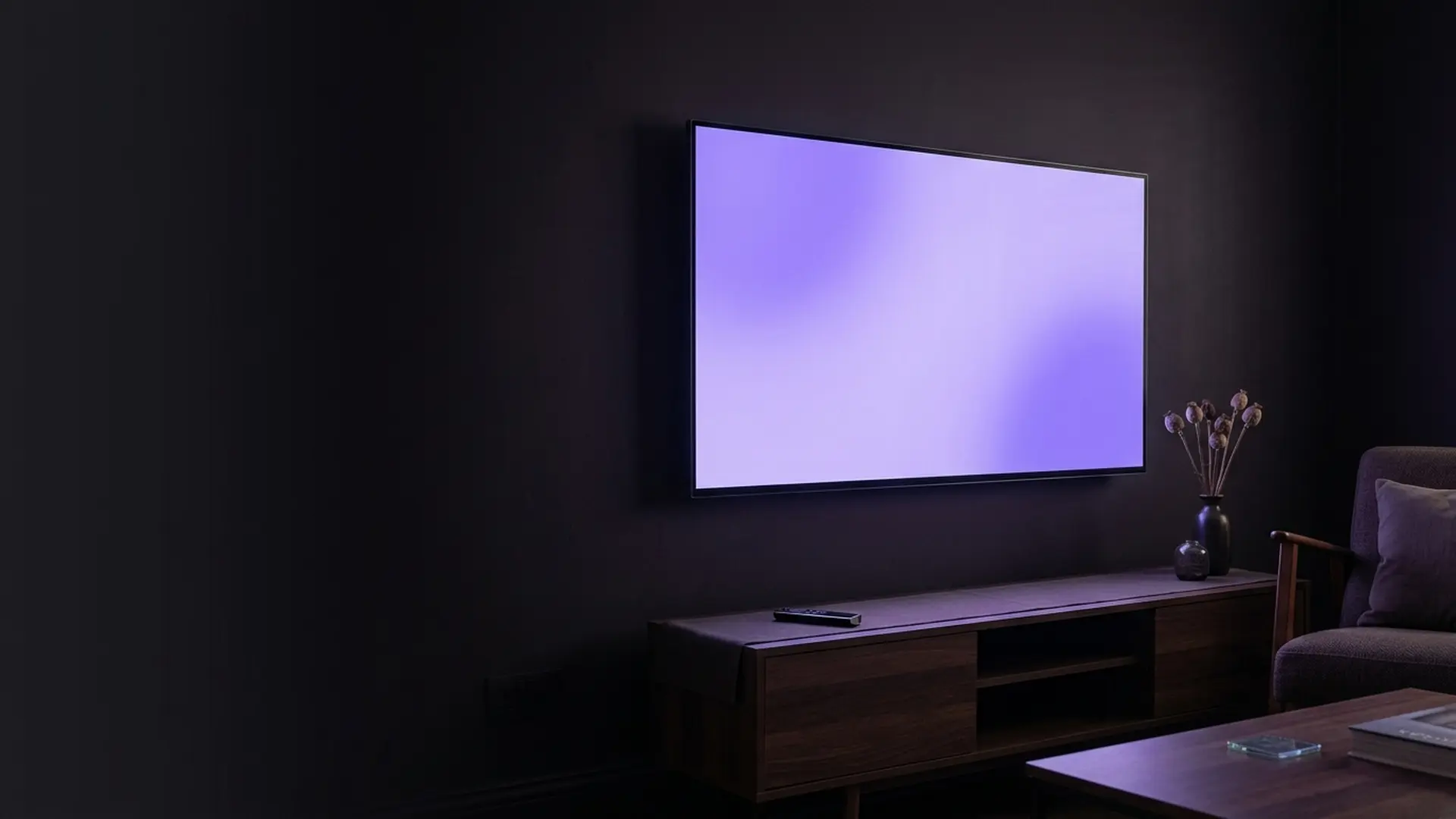 A smart television displaying its home screen in a dark room