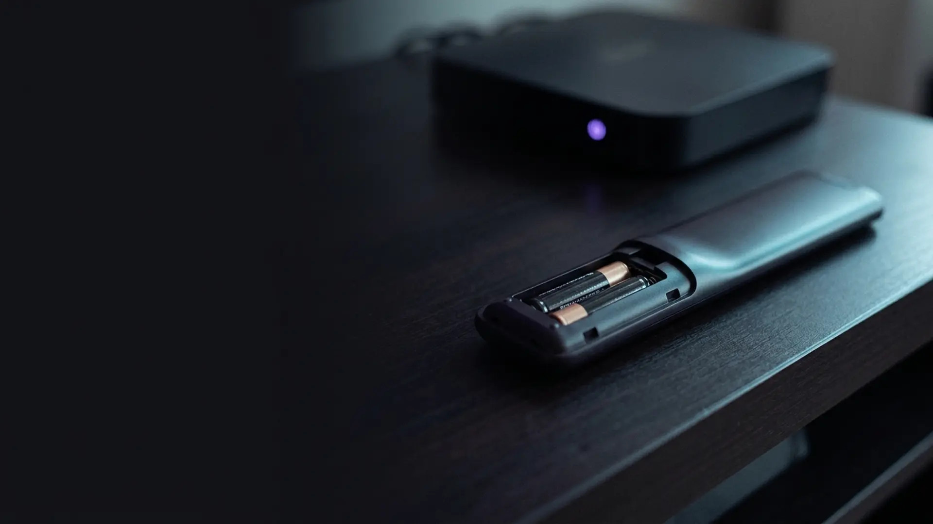 An unresponsive remote on a table in front of a waiting television