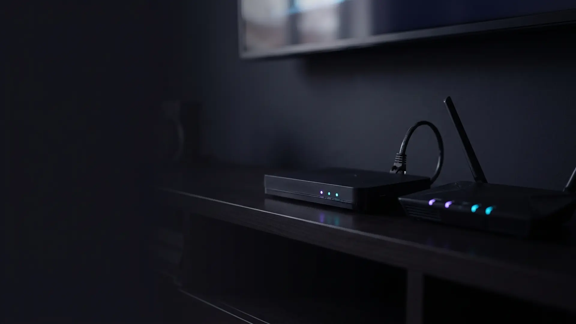 A television box and broadband router stacked together with glowing indicators