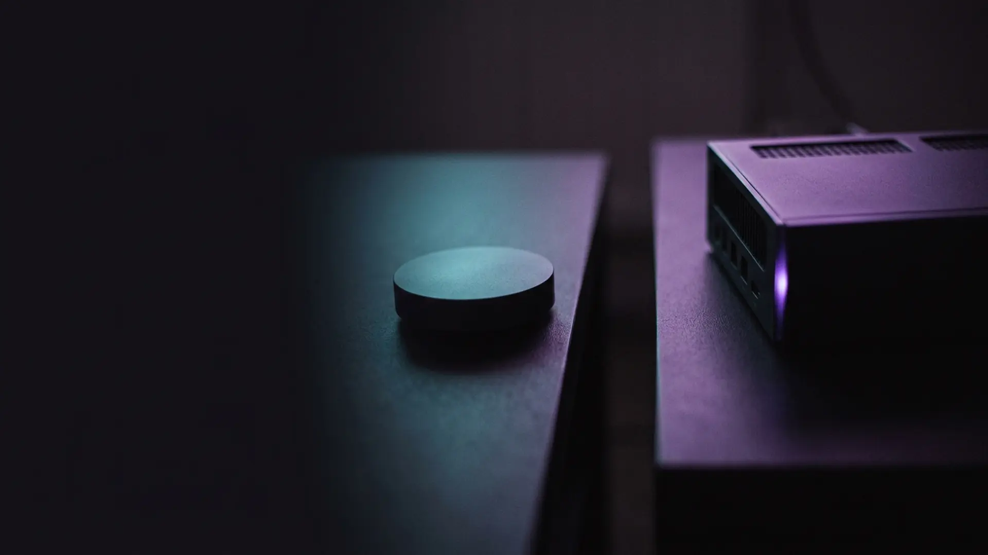 A streaming puck and a set-top box facing each other on plinths