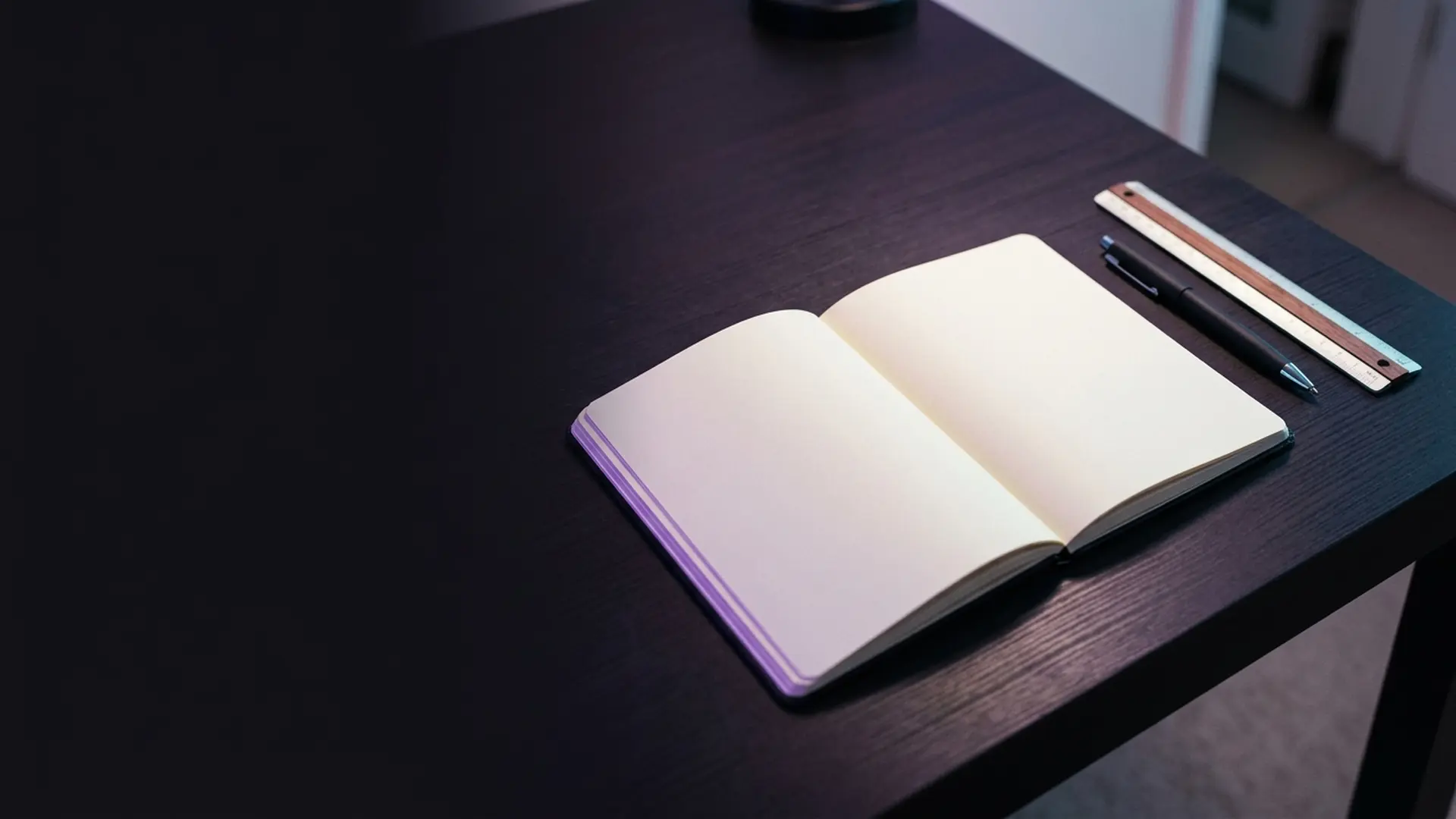 Marked-up proof pages under a desk lamp