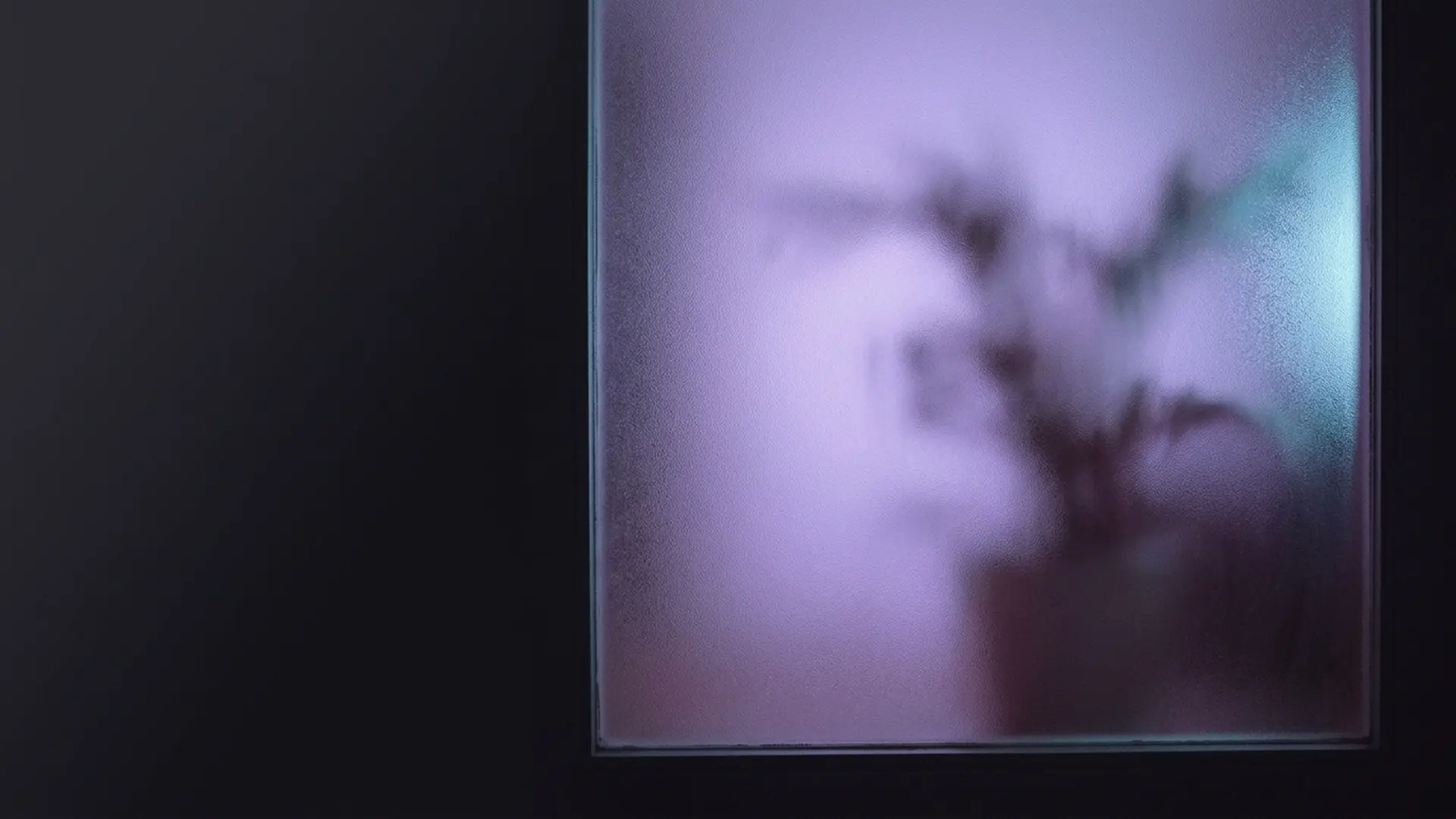 A padlock on dark glass with a soft glow